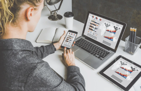 A business owner posting or engaging on social media, preferably in a café or workspace with Boise flair