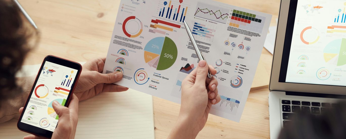 SEO strategy meeting with analytics charts and digital planning tools