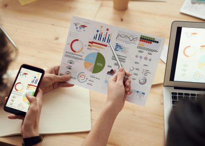 SEO strategy meeting with analytics charts and digital planning tools